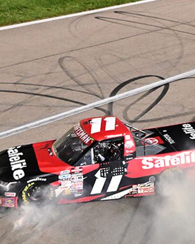 Corey Heim, driver of the #11 Safelite Toyota, celebrates with a burnout after winning the NASCAR Craftsman Truck Series Heart of America 200 at Kansas Speedway on May 04, 2024 in Kansas City, Kansas