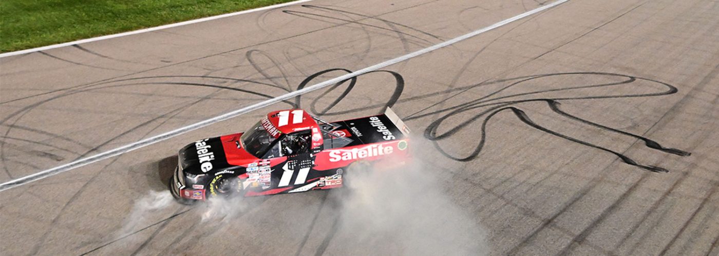 Corey Heim, driver of the #11 Safelite Toyota, celebrates with a burnout after winning the NASCAR Craftsman Truck Series Heart of America 200 at Kansas Speedway on May 04, 2024 in Kansas City, Kansas